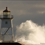 Gales of November: Large waves break against the Grand Marais lighthouse in the fall. Minnesota.