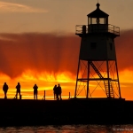 Grand Marais Lighthouse at Sunset: The sunset turns fiery behind the Grand Marais lighthouse. Minnesota.