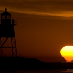 Sticky Sun: A mirage caused by a temperature inversion causes the sun to stick to Lake Superior. Grand Marais, Minnesota. (Featured on spaceweather.com)