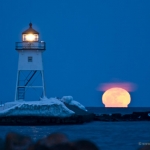 Supermoon: The supermoon, the closest and largest to Earth in about 30 years, rises behind the Grand Marais, Minnesota lighthouse. 110319-40