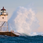 Grand Marais Lighthouse and Waves: Waves wash against the Grand Marais, MN Lighthouse.