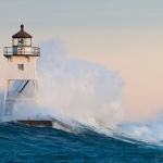 Grand Marais Lighthouse and Waves: Waves wash against the Grand Marais, MN Lighthouse.