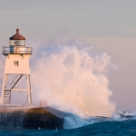 Grand Marais Lighthouse and Waves: Waves wash against the Grand Marais, MN Lighthouse.