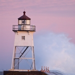 Grand Marais Lighthouse and Waves: Waves wash against the Grand Marais, MN Lighthouse.