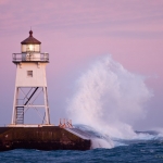 Grand Marais Lighthouse and Waves: Waves wash against the Grand Marais, MN Lighthouse.