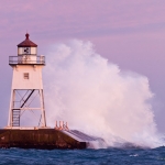 Grand Marais Lighthouse and Waves: Waves wash against the Grand Marais, MN Lighthouse.