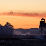 Grand Marais Lighthouse and Waves: Grand Marais Lighthouse and breakwall with waves crashing over.