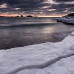 Breaking Up: A crack appears in the shelf ice signaling the end of winter ice. Grand Marais, Minnesota.