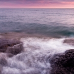 Winter Sunset at Butterwort Cliffs: The sun sets over Lake Superior at Butterwort Cliffs SNA in winter. Minnesota.