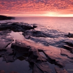 Lake Superior Sunrise: The sun sets the sky on fire over Lake Superior.g