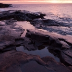 Artist Point Sunrise: The sun sets the sky on fire over Lake Superior.g