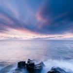 Waves in the Clouds I: Wisps of clouds light up blue and pink at sunrise near Grand Marais, MN.