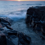 On the Rocks: Sunrise and waves on Lake Superior near Grand Marais, MN.