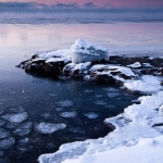 Belt of Venus over Lake Superior: The pink Belt of Venus appears over the wintry Lake Superior shoreline. Cascade River State Park, Minnesota. (110228-12)
