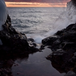 Hourglass Splash: A pool of water collects behind a basalt constriction. Lake Superior's waves splash in the background.