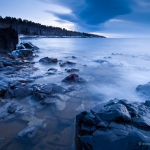 Lake Superior Blue Hour: Just before sunrise a altocumulus cloud hangs over the edge of land. Lake Superior, MN.