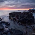 An Artist's Sunrise: The sun rise lights clouds over Lake Superior and Artist's Point. Grand Marais, MN.