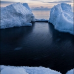 Ice Blocks on Superior: During the last storm, large ice blocks washed up on Lake Superior's shoreline. These fresh-water icebergs provided a nice scene for the sunset. A small swell washed in and moved the frazile ice in a circular motion.