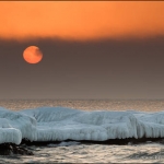 Sun Disk Behind Fog: The sun, veiled behind a thin layer of fog, rises over Lake Superior. Paradise Beach, Minnesota. (110216-46)