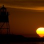 A mirage caused by a temperature inversion causes the sun to stick to Lake Superior. Grand Marais, Minnesota. (Featured on spaceweather.com)