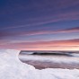 In the depths of winter, waves wash up against ice formations along Lake Superior's shoreline.