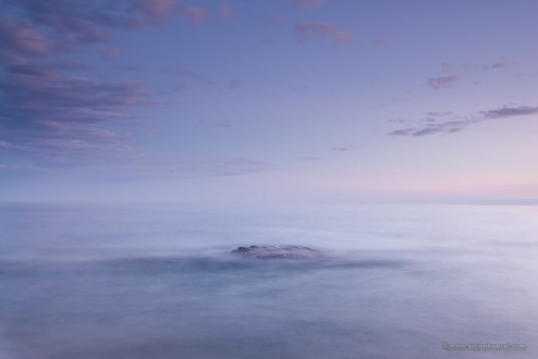 Lake Superior waves wash over a rock in this long exposure image. Artist's Point, Grand Marais, MN.