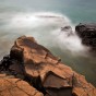 Lake Superior waves wash over rocks.