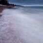 Waves wash over stones on Lake Superior.
