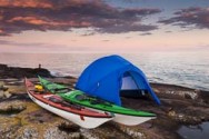 The sun sets of Lake Superior on a kayak campsite near Grand Marais, MN.