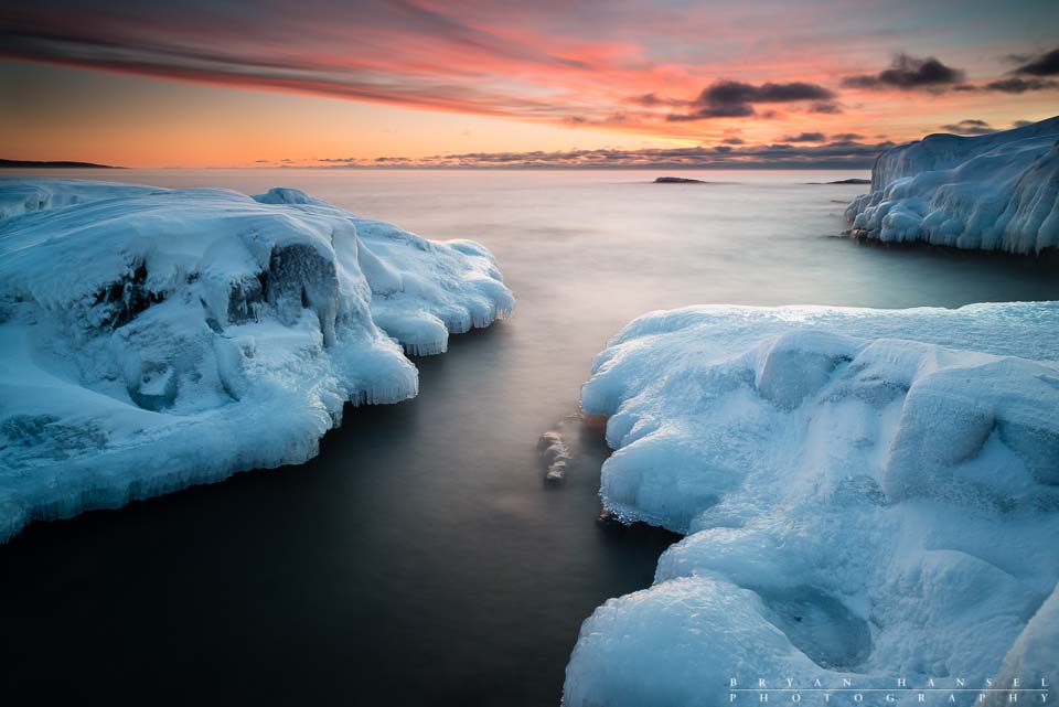 The dawn breaks the winter chill and lights up the sky over Lake Superior. Grand Marais, Minnesota.
