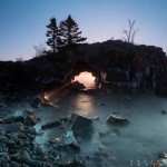 Permalink to January Newsletter: What to Wear for Winter Photography The sun breaks through Hollow Rock, which is near Grand Portage, Minnesota.
