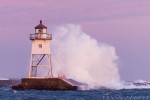 Waves wash against the Grand Marais, MN Lighthouse.