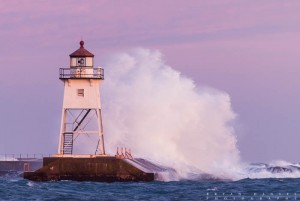 Waves wash against the Grand Marais, MN Lighthouse.