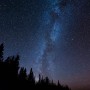 The Milky Way lights up the sky over Cascade Lake in the early winter. Minnesota.
