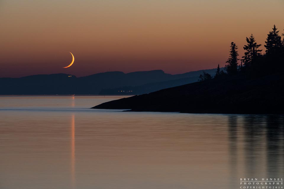 crescent moon sets over Lutsen Resort
