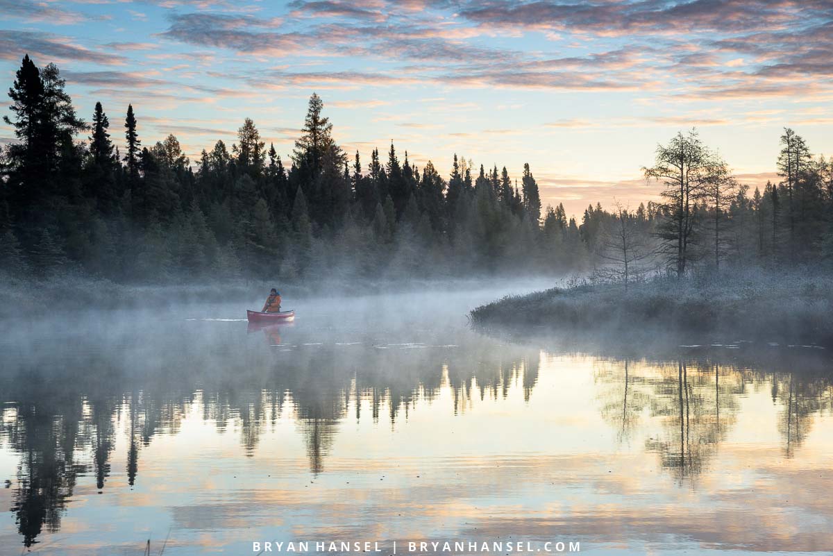 paddling a canoe on a foggy morning